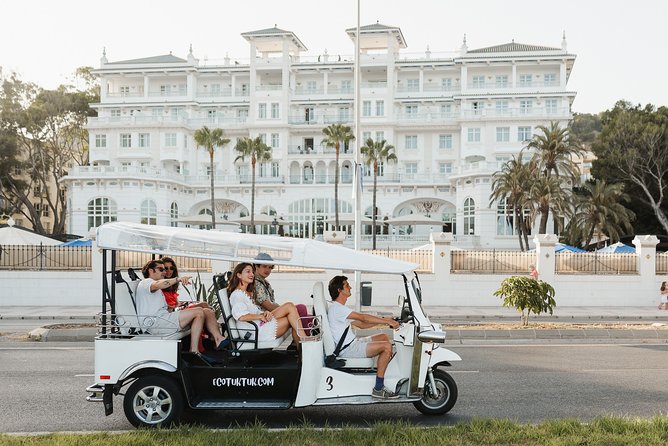 Malaga Expert Tour with Local Guide in Eco Tuk Tuk Private - La Farola and La Malagueta Beach: lighthouse history plus dark sand seaside